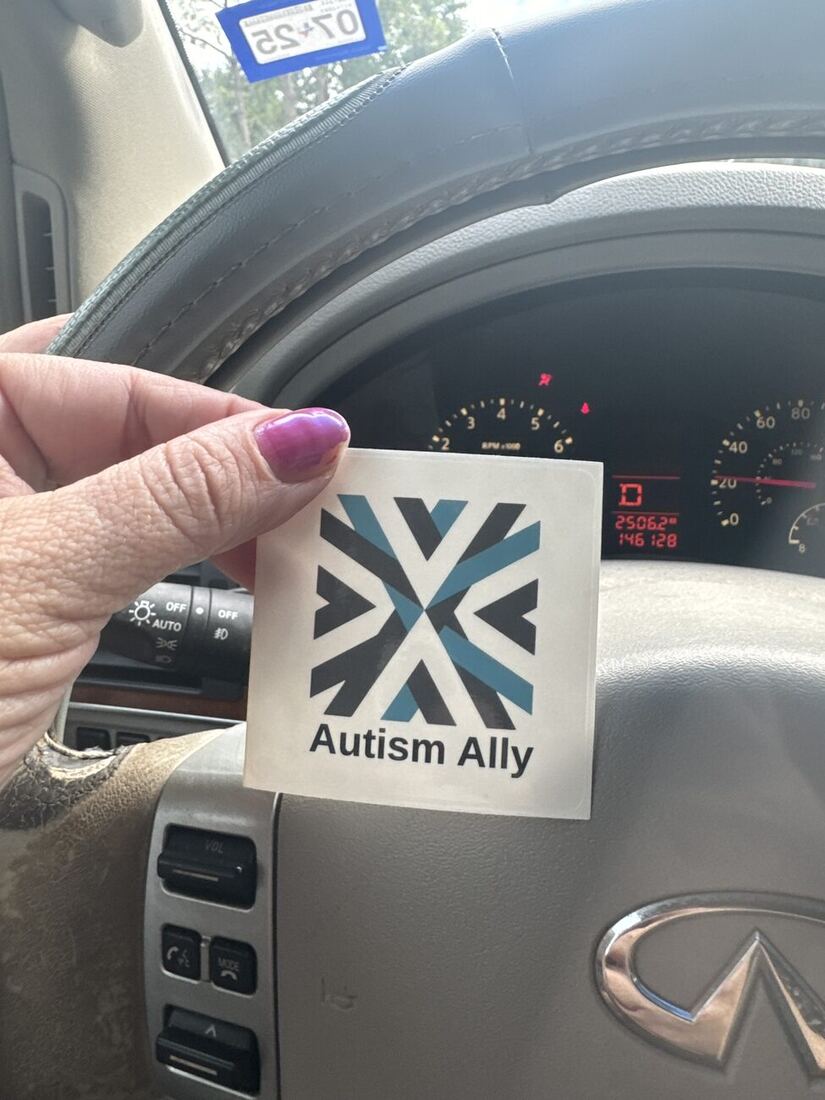 The Autism Ally sticker on a car window.