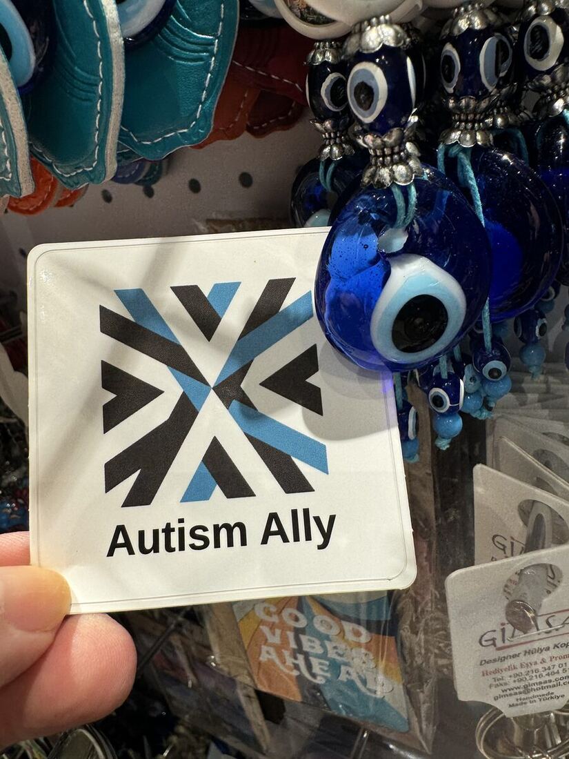 The Autism Ally sticker in a shop window.
